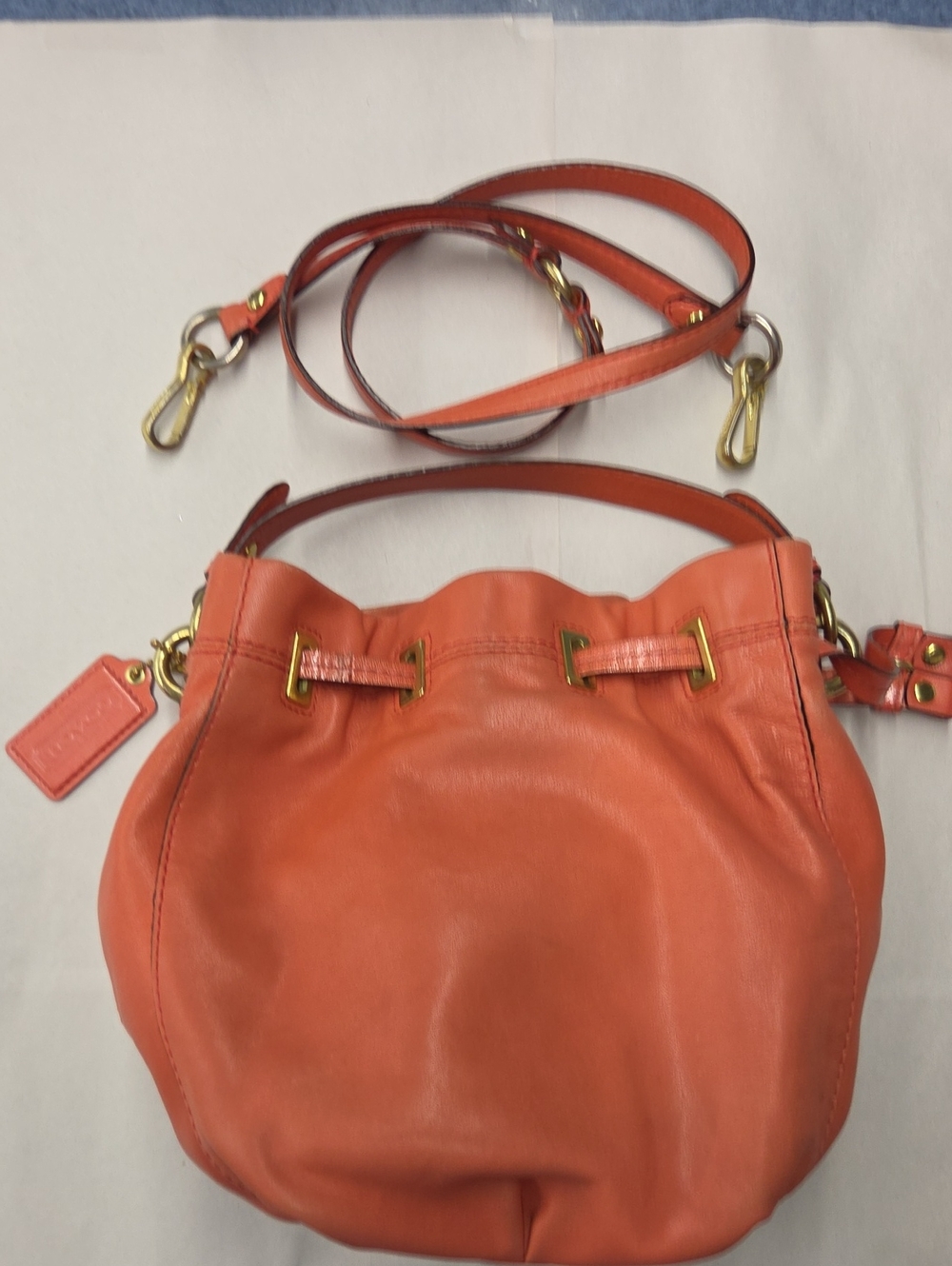 Coach Peyton Leather Drawstring Crossbody Bag In Melon Color